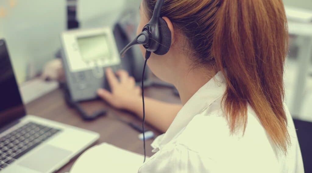 A woman with a headset working at an answering service