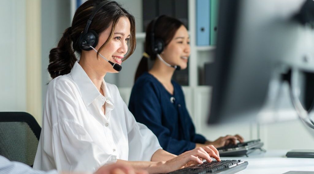 Two women working in a call center