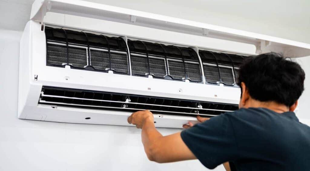 A technician installing an air conditioner unit A technician installing an air conditioner unit.
