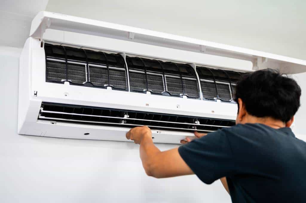 A technician installing an air conditioner unit.